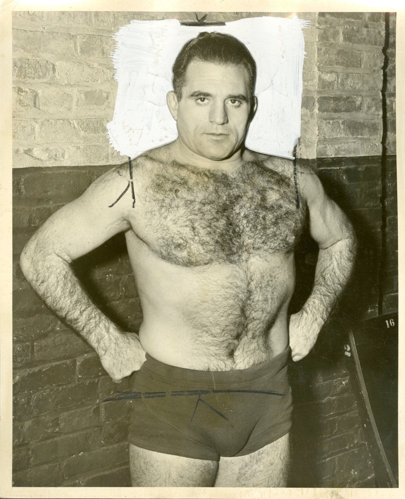 Michele Leone with his hands at his sides in wrestling trunks