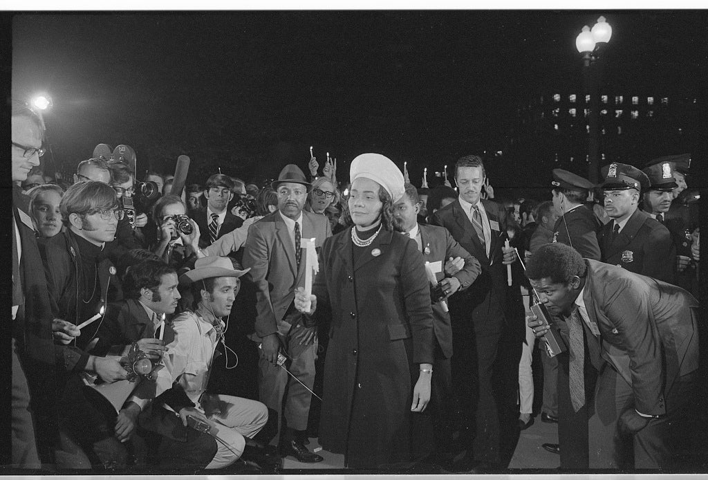 Coretta Scott King holding a candle and leading a march at night to the White House as part of the Moratorium to End the War in Vietnam