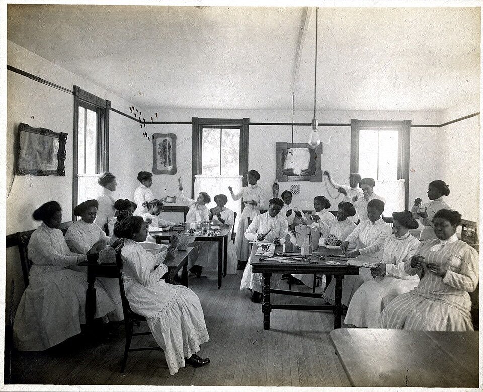 a vocational classroom with students doing various domestic tasks