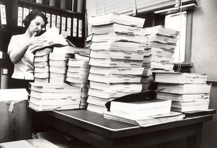 Chemist Lee Geismar, who was part of the team that reviewed the new drug application for thalidomide in the early 1960s, is shown some years later poring over several volumes of another application