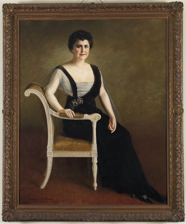 1920 portrait of Edith Wilson in a black dress seated in a chair. Source: White House Historical Association.