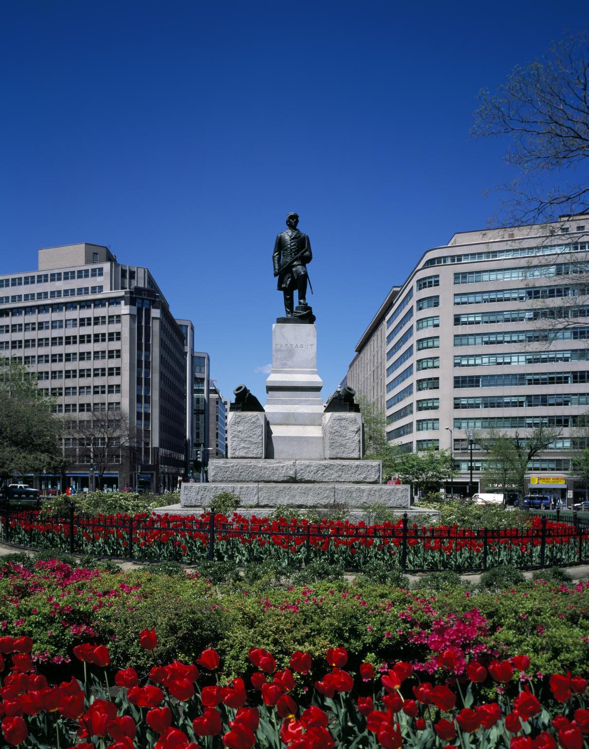 Statue of solider with modern office buildings in the background. Pedestal reads "Farragut."
