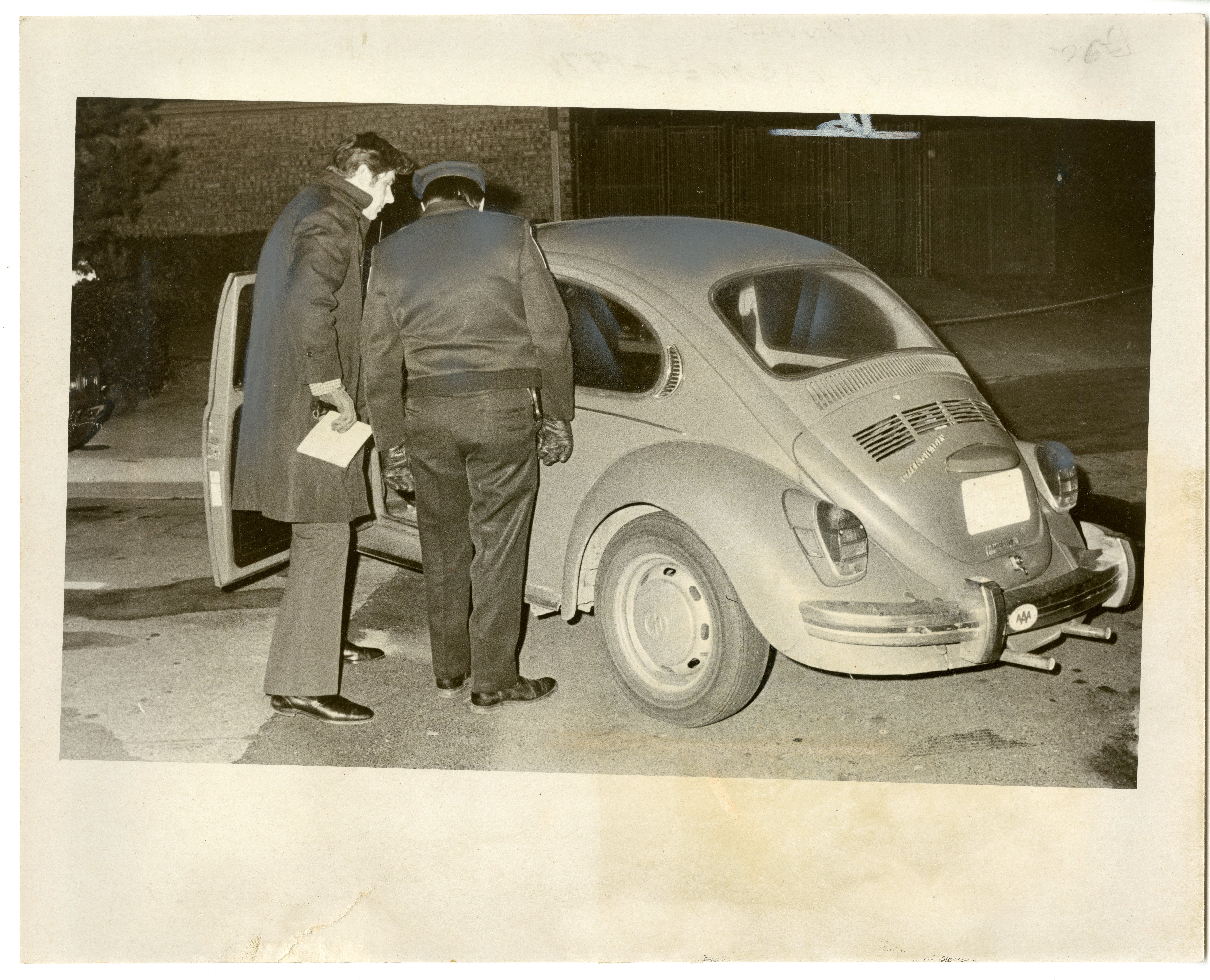 Police inspect Volkswagon beetle, which four inmates used as a getaway vehicle after they escaped from Lorton on Christmas night in 1974. (Photo Credit: Geoffrey Gilbert, Reprinted with permission of the DC Public Library, Star Collection, © Washington Post.) Police inspect Volkswagon beetle, which four inmates used as a getaway vehicle after they escaped from Lorton on Christmas night in 1974. (Photo Credit: Geoffrey Gilbert, Reprinted with permission of the DC Public Library, Star Collection, © Washington Post.)