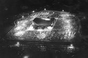 Nightime aerial photograph of Capital Center arena surrounded by parking lots.