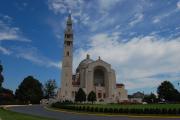 Basilica of the National Shrine of the Immaculate Conception against blue sky.