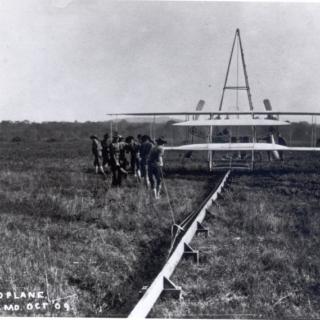 Soldiers help start the Wright Military Flyer (Wright Aeroplane) from the monorail at the College Park Airfield, October 1909. The plane is at the end of the catapult. Photo courtesy of the College Park Aviation Museum.