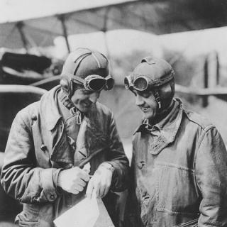 Major Reuben Fleet and Lieutenant George Boyle standing in front of the Jenny plane with a map.