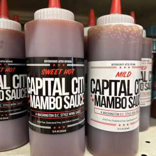 Capital City Mumbo Sauce bottles on grocery store shelf in DMV. (Credit: Mark Jones)