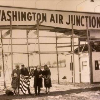 Black and white photo of Henry Woodhouse and guests standing in front of George Washington Air Junction entrance, from 1929-30.