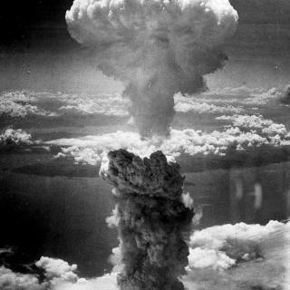 Black and white aerial photo of mushroom cloud from atomic bombing of Nagasaki, Japan in August 1945.