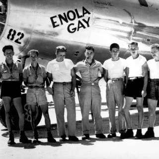 A crew of Air Force soldiers below a plane fuselage