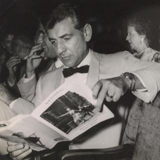 Leonard Bernstein reads playbill for West Side Story at the musical's premiere at the National Theater in Washington, DC on August 12, 1957. (Source: Library of Congress)