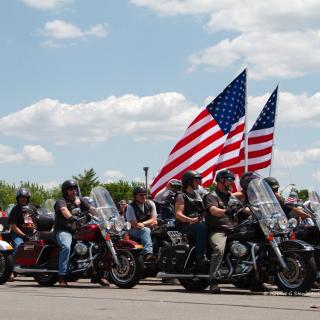 Rolling Thunder participants on their motorcycles with American flags in 2014. (Photo credit: Flickr user Robert Stankiewicz. Used via CC BY-SA 2.0 license.)