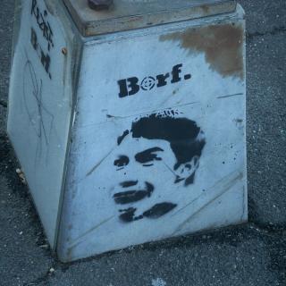 a spray-painted BORF face on a lamppost