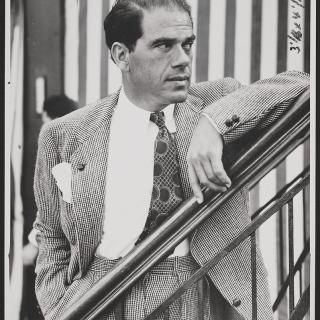 Frank Capra dressed in coat and tie looking from left to right in 1937. (Source: Library of Congress)