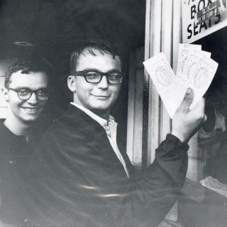 Two fans standing outside the RFK stadium ticket window holding tickets to the 1969 All Star game.