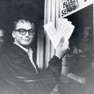 Two fans standing outside the RFK stadium ticket window holding tickets to the 1969 All Star game.