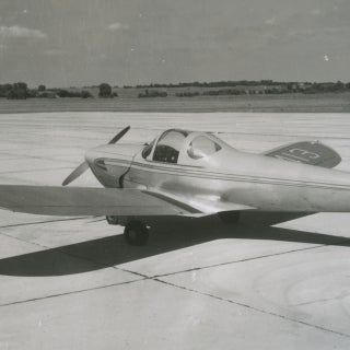 Small airplane sitting on runway.