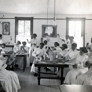 a vocational classroom with students doing various domestic tasks