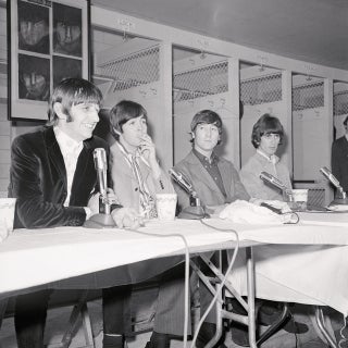 The Beatles hold a press conference in the Washington Senators locker room before their final D.C. concert on August 15, 1966 (Bettmann via Getty Images).