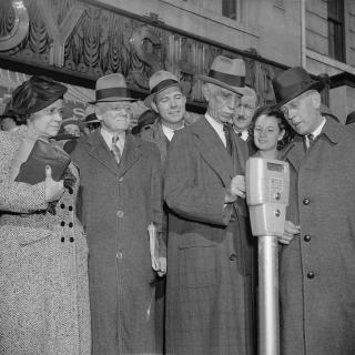 Commissioner Melvin Hazen and William Van Duzer, putting the first nickel in the parking meters ordered by Congress for a test in Washington in November 1938. 