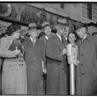 Commissioner Melvin Hazen and William Van Duzer, putting the first nickel in the parking meters ordered by Congress for a test in Washington in November 1938. 
