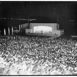 Hans Kindler conducts the NSO on the concert barge at the Watergate Amphitheatre in 1939.  (Photo Source: Library of Congress) https://www.loc.gov/pictures/item/hec2009013682/