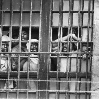 Inmates shouting through D.C. Jail window during the hostage standoff on October 11, 1972. (Photo Credit: Unknown, Courtesy DC Public Library, Star Collection, © Washington Post, All Rights Reserved.)
