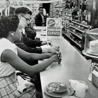 Activists at drug store counter in Arlington. (Source: Washington Area Spark on Flickr.)