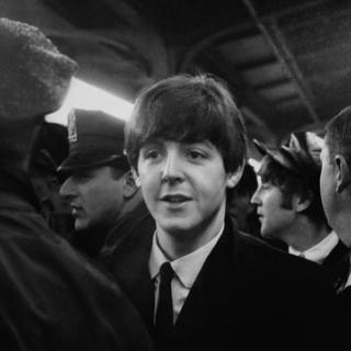 Paul McCartney and John Lennon are ushered through the crowd at Union Station on February 11, 1964. (Photo credit: Mike Mitchell)