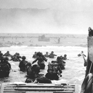 U.S. Soldiers disembark a landing craft at Normandy, France, June 6, 1944. By the end of the day some 150,000 Allied troops had landed on five Normandy beaches and three airborne drop zones. The invasion marked the beginning of the final phase of World War II in Europe, which ended with the surrender of Germany the following May. (Source: Wikimedia Commons, U.S. Department of Defense photo courtesy of the National Infantry Museum/Released) 