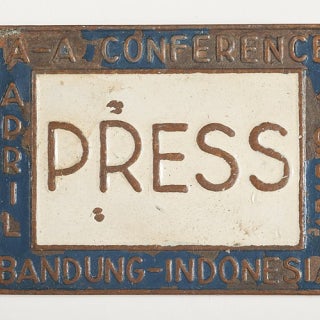 A copy of Ethel Payne's press pass for the Bandung Asian-African Conference. The pin is labeled "Press" and the conference title rings the label. 