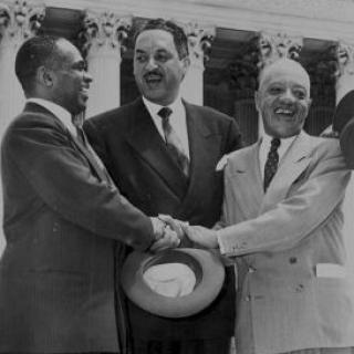 George E.C. Hayes, Thurgood Marshall, and James Nabrit Jr congratulate each other outside of the Supreme Court on the day of the decision