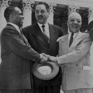 George E.C. Hayes, Thurgood Marshall, and James Nabrit Jr congratulate each other outside of the Supreme Court on the day of the decision