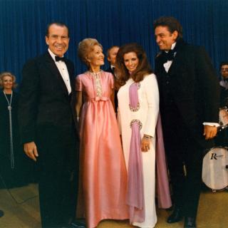 The Nixons and the Cashes pose for a photo on the evening that Cash performed at the White House. Image Source: National Archives.