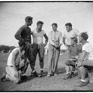 George Marshall, owner of the Washington Redskins, talks it over with some of his players, left to right: Wayne Millner, tackle, end, Charlie Malone, end,. Vic Carroll, Tackle,. George Marshall, Bill Young, Tackle, Ed Michaels, Guard, Jim Garber, Tackle,. 9/11/37