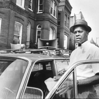 Hobson with his station wagon and trademark pipe and fedora, ready to harangue the multitudes. (Source: Evening Star) 