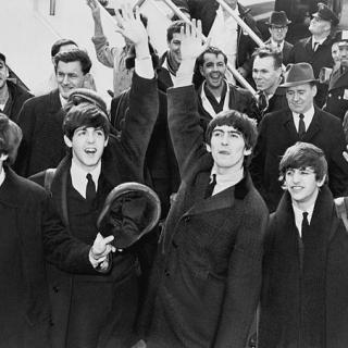 The Beatles were greeted by thousands of screaming teenagers when they arrived at Kennedy airport in New York on February 7, 1964. When they played their first American concert at the Washington Coliseum four days later, they were pelted with jellybeans while on stage. (Photo source: Wikipedia)