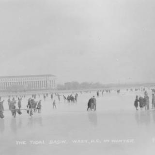 Black and white photo of people ice skating and walking on the Tidal Basin