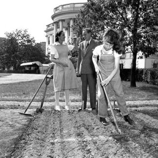 Diana Hopkins hoes her victory garden at the White House as her parents look on. (Source: AP)