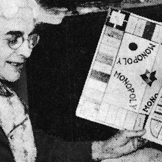 Elizabeth Magie comparing a copy of “Monopoly” to “The Landlord’s Game.” (Image source: “Designed to Teach,” Evening Star, January 28, 1936.)