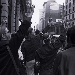 Hundreds of draft protestors stand outside the courthouse where the trial of the Catonsville Nine takes place, peace signs up in support of the Nine. (Source: William Morgenstern, [War and draft protest], 1968. Gelatin silver print. University Archives, University of Maryland, Baltimore County, UARC Photos-09-01-0025.)
