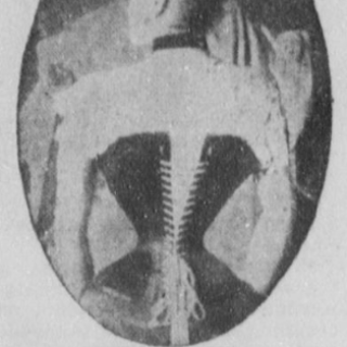 Woman with tight corset seen from the back.