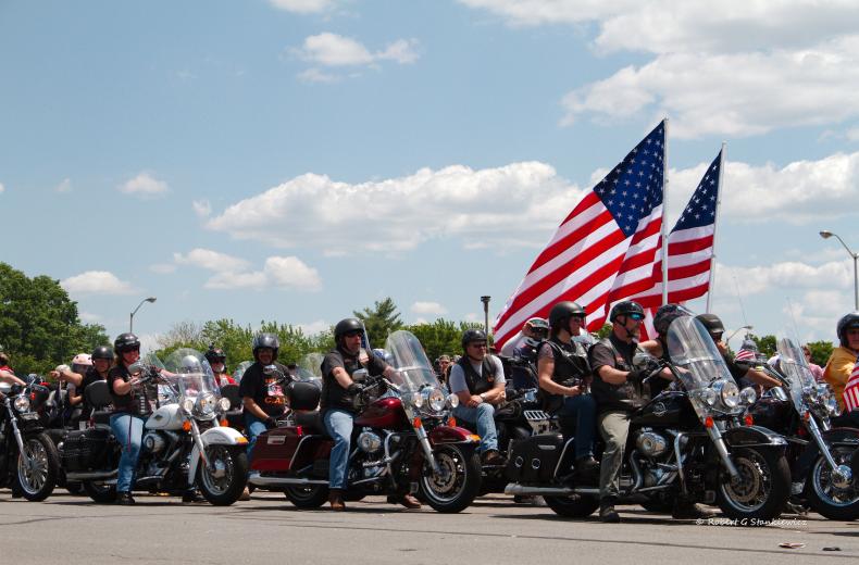 Rolling Thunder participants on their motorcycles with American flags in 2014. (Photo credit: Flickr user Robert Stankiewicz. Used via CC BY-SA 2.0 license.)