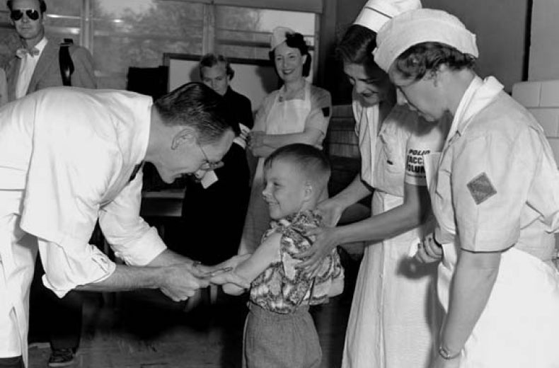 Dr. Richard Mulvaney administers the trial Polio vaccine to Randall Kerr with two nurses looking on