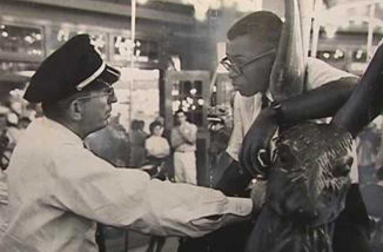 Officer Frank Collins confronts Laurence Henry on Glen Echo's Dentzel Carousel on June 30, 1960. (Photo source: National Park Service)