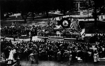 A large crowd amasses at Dupont Circle. There are many American flags being waved, and a large brass band to the left helps celebrate the opening of the Dupont Circle Underpass