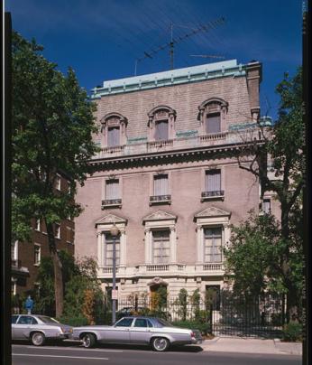 The facade of the Pullman house above 16th street with a car in front of it