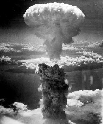 Black and white aerial photo of mushroom cloud from atomic bombing of Nagasaki, Japan in August 1945.