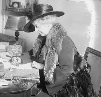 A photo of Calhoun writing at a desk in 1923